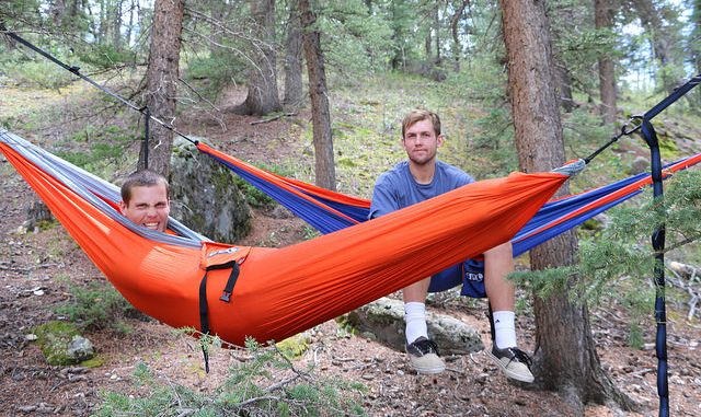 Two men in camping hammocks