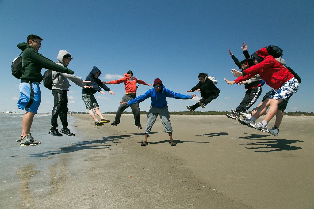 Teens jumping outdoors on the beach