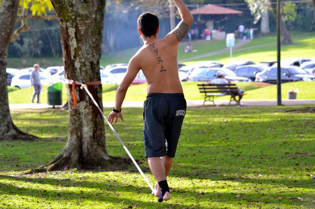 Man balancing on a slackline in the park