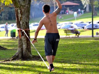 Man balancing on a slackline in the park