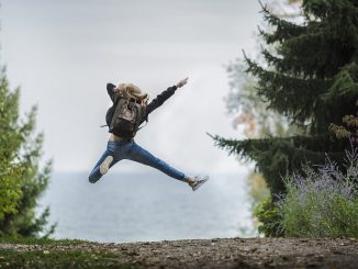 Woman jumping for joy outdoors, full of health and resilience