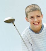 Boy enjoying playing golf outdoors