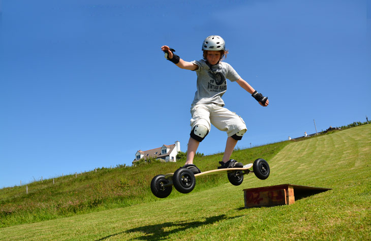 Mountain boarding over a jump