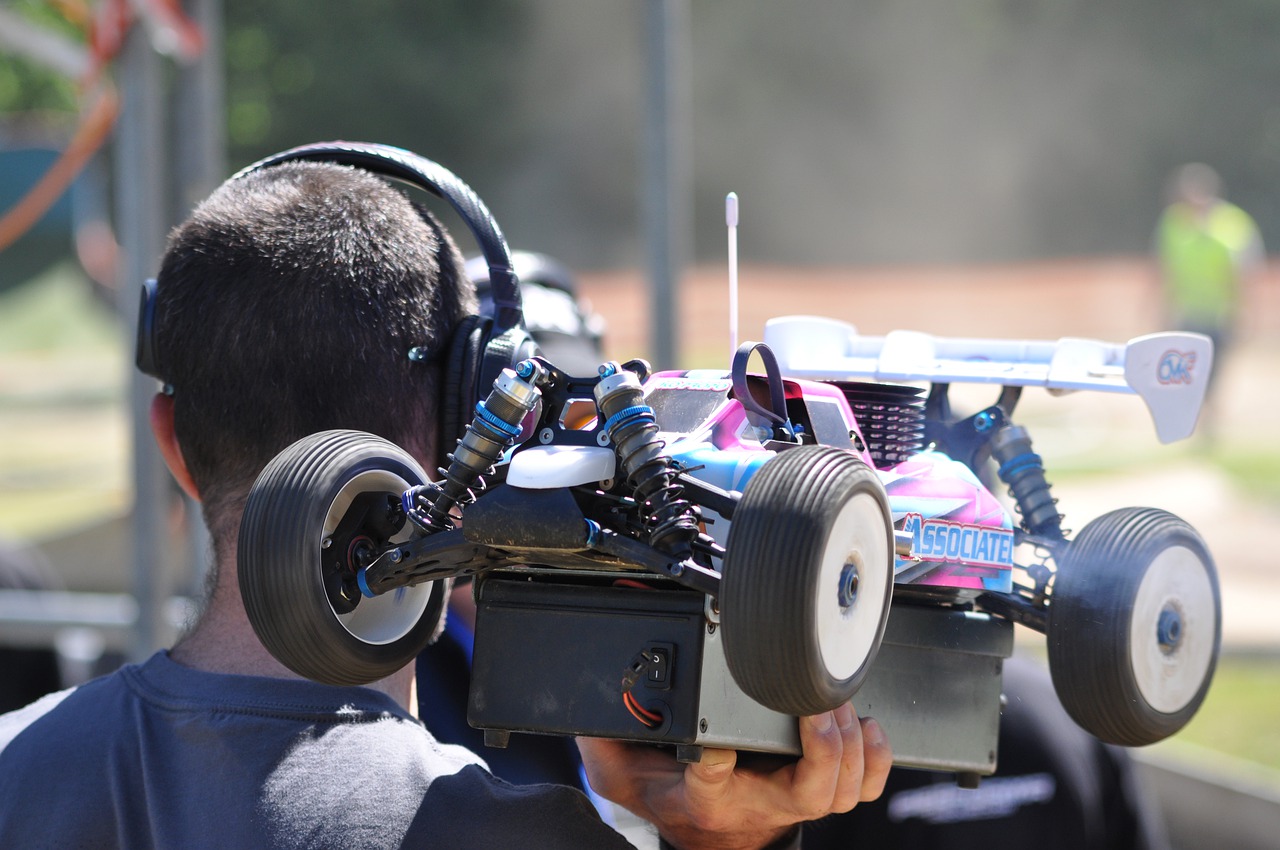 man holding his rc car ready for racing