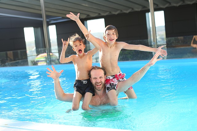 Dad and his boys having fun swimming