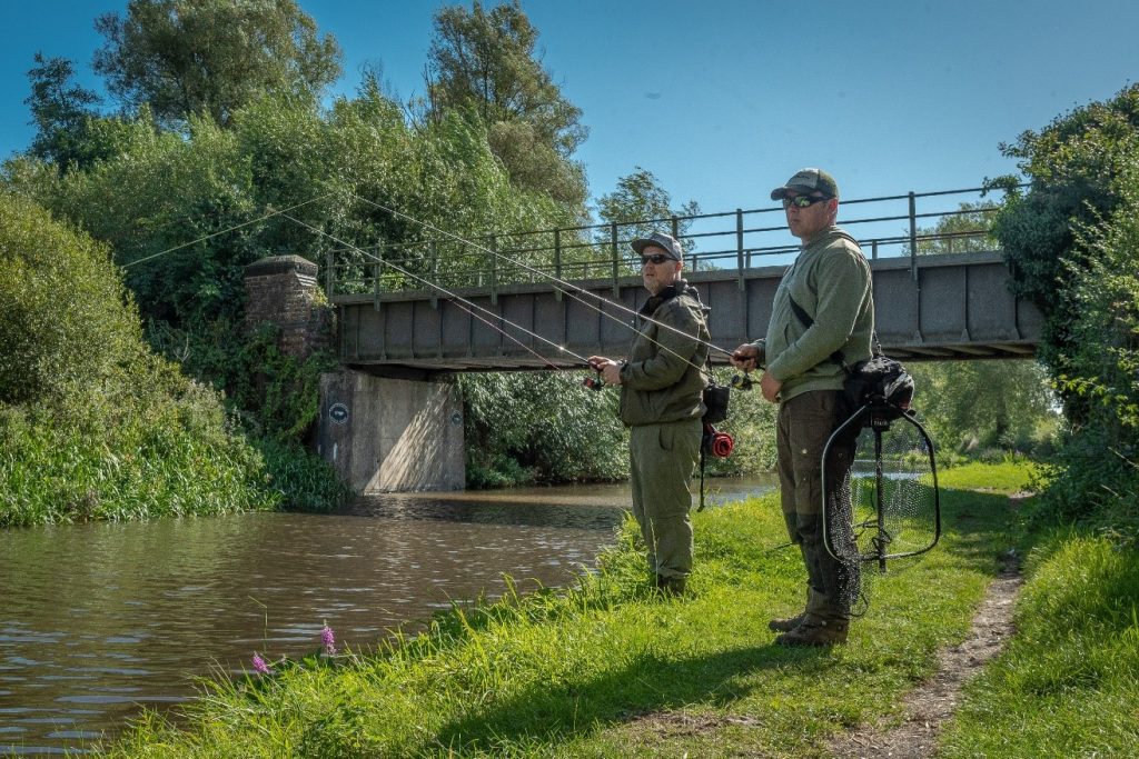 Fishing with friends on a canal