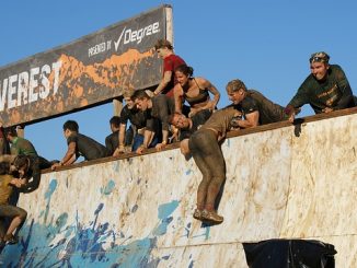 Climbing a wall on the Tough Mudder obstacle course race